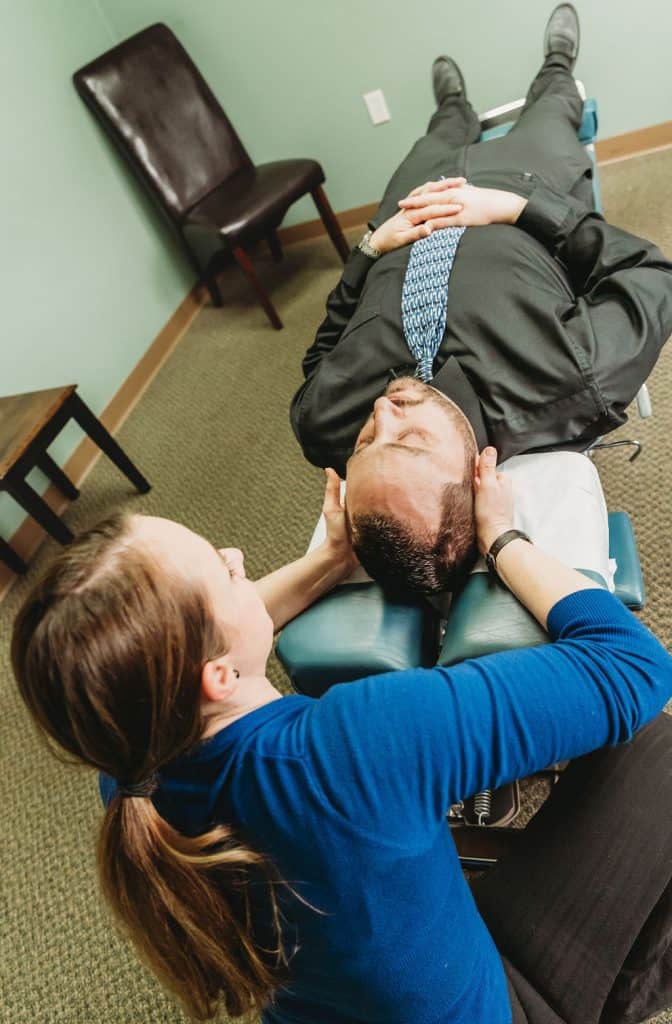Dr Kali treating headache pain with chiropractic adjustment